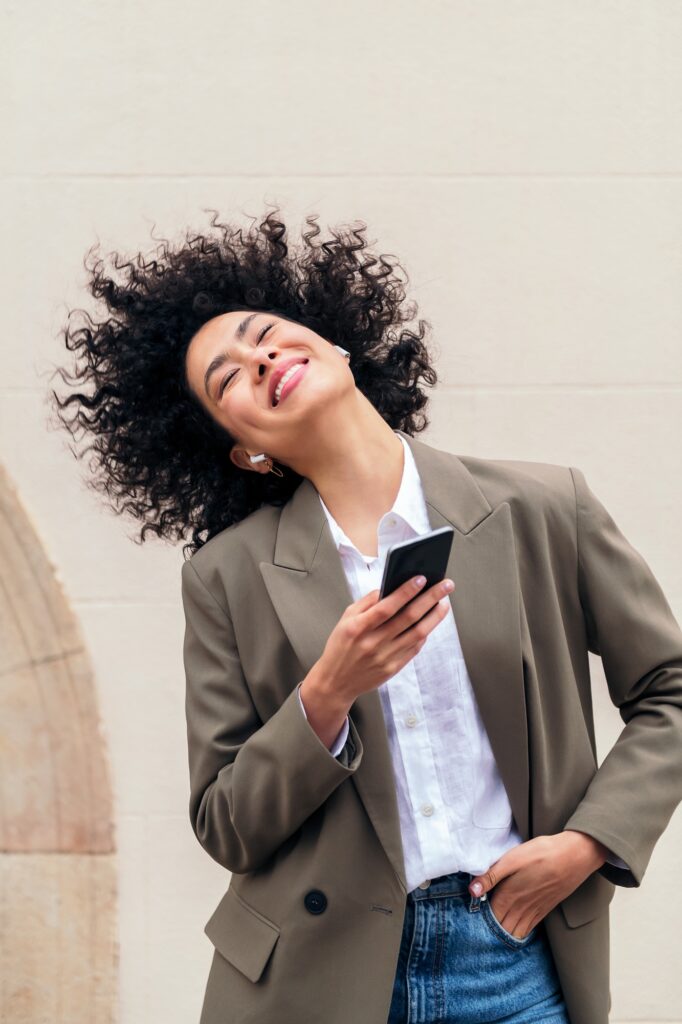 happy woman with earphones dancing with the music